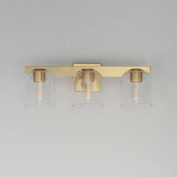Cut-out metalwork curves around modern bell-shaped glass shades. The series includes pendants and bath vanities available in either Clear or a swirling Marble glass. Available in various complementary finishes: Polished Chrome, Matte Black, or Natural Aged Brass these fixtures make a delightful addition to bathroom spaces, bedrooms, or over a kitchen island. Collection: Scoop Finish: Natural Aged Brass Glass: Clear Width: 21.50" Height: 8.00" Weight: 6.60 lb Extension from Wall: 7.00" Wire: 6" Canopy: 5"x5" Number of Bulbs: 3 Maximum Wattage: 60.00 W Bulb Type: E26 Bulb Base: E26 Medium Light Source: Incandescent Dimmable Voltage: 120.00 V Material: Steel, Glass Safety Listing: cULus Safety Rating: Damp Manufacturer Warranty: 3 Spec Sheet Instructions - alternate view