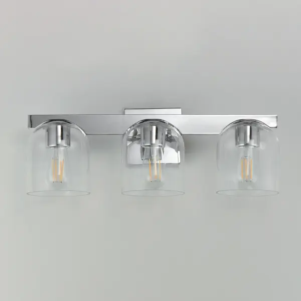 Cut-out metalwork curves around modern bell-shaped glass shades. The series includes pendants and bath vanities available in either Clear or a swirling Marble glass. Available in various complementary finishes: Polished Chrome, Matte Black, or Natural Aged Brass these fixtures make a delightful addition to bathroom spaces, bedrooms, or over a kitchen island. Collection: Scoop Finish: Polished Chrome Glass: Clear Width: 21.50" Height: 8.00" Weight: 6.60 lb Extension from Wall: 7.00" Wire: 6" Canopy: 5"x5" Number of Bulbs: 3 Maximum Wattage: 60.00 W Bulb Type: E26 Bulb Base: E26 Medium Light Source: Incandescent Dimmable Voltage: 120.00 V Material: Steel, Glass Safety Listing: cULus Safety Rating: Damp Spec Sheet Instructions - alternate view