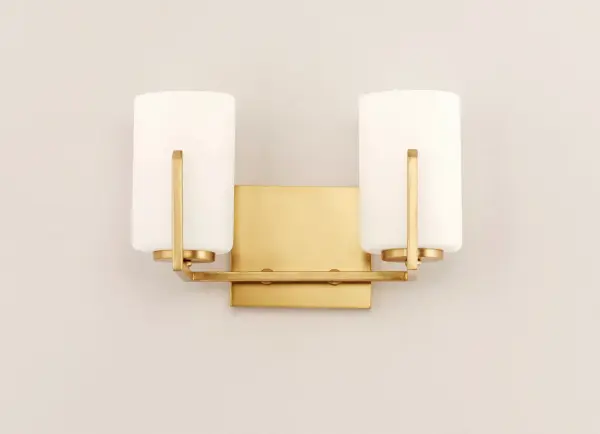 Inspired by the Modernist architect Edward Dart, this collection features straight line frames finished in Satin Brass, Satin Nickel, or Matte Black that support Satin White glass cylinders for a clean and modern look. The frames' ends turn up before the glass in sharp mitered angles emphasizing a minimalist geometry popular in Modernist work. Collection: Dart Finish: Satin Brass Glass: Satin White Width: 12.50" Height: 7.75" Length: 5.75" Weight: 2.34 lb Extension from Wall: 5.75" Wire: 8" Canopy: 4.75"x5.5" Number of Bulbs: 2 Maximum Wattage: 60.00 W Bulb Type: A19 Bulb Base: E26 Medium Light Source: Incandescent Dimmable Voltage: 120.00 V Material: Steel, Glass Safety Listing: cETLus Safety Rating: Damp Manufacturer Warranty: 3 Spec Sheet Instructions Parts Diagram - alternate view