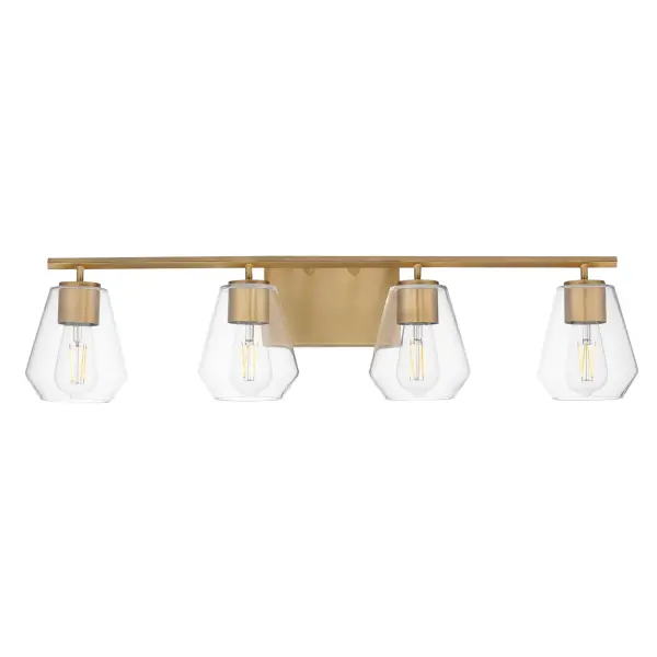 Crystalline clarity meets modern structure in the Geode collection. Inspired by the faceted symmetry of natural mineral formations, each clear glass shade is cut in an angular form that plays with light and shadow. The bold, geometric silhouette feels effortlessly architectural -- elevated further by subtle industrial notes like knurled screw collars and diamond shaped tubing on bath configurations. Offered in a range of sizes and finishes, Geode brings sculptural interest to kitchens, bathrooms, and dining rooms as well as statement-making entryways. Collection: Geode Finish: Natural Aged Brass Glass: Clear Width: 31.25" Height: 7.75" Weight: 5.30 lb Extension from Wall: 6.50" Wire: 8" Canopy: 4.75"x7" Number of Bulbs: 4 Maximum Wattage: 60.00 W Bulb Type: A19 Bulb Base: E26 Medium Light Source: Incandescent Voltage: 120.00 V Material: Steel, Glass Safety Listing: cULus Safety Rating: Damp Manufacturer Warranty: 3 Spec Sheet