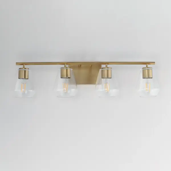 Crystalline clarity meets modern structure in the Geode collection. Inspired by the faceted symmetry of natural mineral formations, each clear glass shade is cut in an angular form that plays with light and shadow. The bold, geometric silhouette feels effortlessly architectural -- elevated further by subtle industrial notes like knurled screw collars and diamond shaped tubing on bath configurations. Offered in a range of sizes and finishes, Geode brings sculptural interest to kitchens, bathrooms, and dining rooms as well as statement-making entryways. Collection: Geode Finish: Natural Aged Brass Glass: Clear Width: 31.25" Height: 7.75" Weight: 5.30 lb Extension from Wall: 6.50" Wire: 8" Canopy: 4.75"x7" Number of Bulbs: 4 Maximum Wattage: 60.00 W Bulb Type: A19 Bulb Base: E26 Medium Light Source: Incandescent Voltage: 120.00 V Material: Steel, Glass Safety Listing: cULus Safety Rating: Damp Manufacturer Warranty: 3 Spec Sheet - alternate view