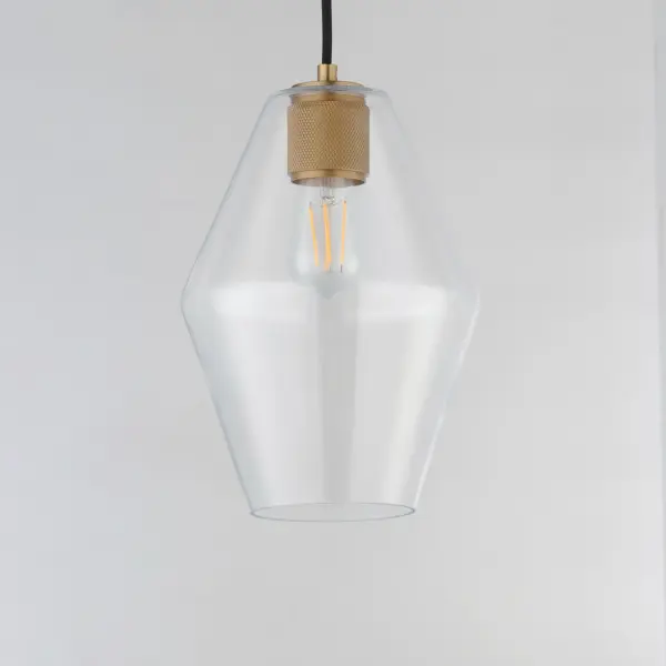 Crystalline clarity meets modern structure in the Geode collection. Inspired by the faceted symmetry of natural mineral formations, each clear glass shade is cut in an angular form that plays with light and shadow. The bold, geometric silhouette feels effortlessly architectural -- elevated further by subtle industrial notes like knurled screw collars and diamond shaped tubing on bath configurations. Offered in a range of sizes and finishes, Geode brings sculptural interest to kitchens, bathrooms, and dining rooms as well as statement-making entryways. Collection: Geode Finish: Natural Aged Brass Glass: Clear Width: 8.70" Height: 13.00" Weight: 2.70 lb Wire: 120" Canopy: 5"x5"x0.7" Number of Bulbs: 1 Maximum Wattage: 60.00 W Bulb Type: A19 Bulb Base: E26 Medium Light Source: Incandescent Voltage: 120.00 V Material: Steel, Glass Safety Listing: cULus Safety Rating: Dry Manufacturer Warranty: 3 Spec Sheet - alternate view