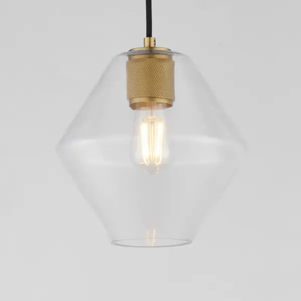 Crystalline clarity meets modern structure in the Geode collection. Inspired by the faceted symmetry of natural mineral formations, each clear glass shade is cut in an angular form that plays with light and shadow. The bold, geometric silhouette feels effortlessly architectural -- elevated further by subtle industrial notes like knurled screw collars and diamond shaped tubing on bath configurations. Offered in a range of sizes and finishes, Geode brings sculptural interest to kitchens, bathrooms, and dining rooms as well as statement-making entryways. Collection: Geode Finish: Natural Aged Brass Glass: Clear Width: 9.50" Height: 10.00" Weight: 2.90 lb Wire: 120" Canopy: 5"x5"x0.7" Number of Bulbs: 1 Maximum Wattage: 60.00 W Bulb Type: A19 Bulb Base: E26 Medium Light Source: Incandescent Voltage: 120.00 V Material: Steel, Glass Safety Listing: cULus Safety Rating: Dry Manufacturer Warranty: 3 Spec Sheet - alternate view