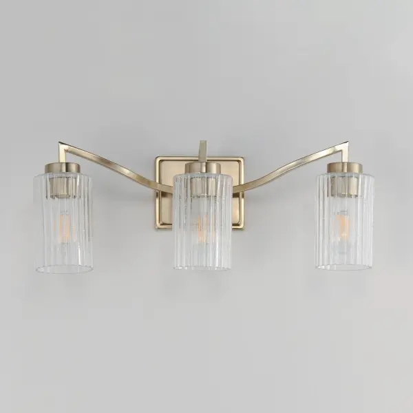 Clear Ribbed glass cylinders are supported on gracefully sweeping frames. The glass pattern helps to diffuse the light source while adding texture and style to the design. Available in Polished Nickel, Satin Champagne, or Matte Black. Collection: Rigata Finish: Satin Champagne Glass: Clear Ribbed Width: 22.75" Height: 8.50" Weight: 6.30 lb Extension from Wall: 5.75" Wire: 8" Canopy: 5"x6" Number of Bulbs: 3 Maximum Wattage: 60.00 W Bulb Type: A19 Bulb Base: E26 Medium Light Source: Incandescent Dimmable Voltage: 120.00 V Material: Steel, Glass Safety Listing: cULus Safety Rating: Damp Manufacturer Warranty: 3 Spec Sheet Instructions - alternate view