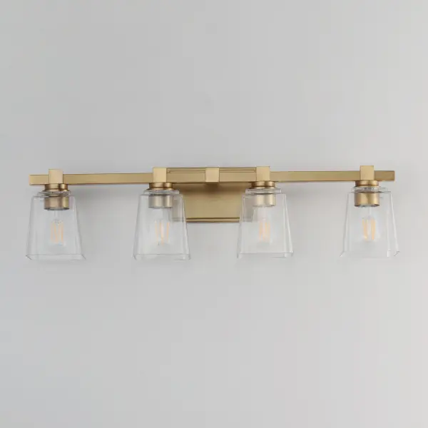 A composition of square forms that feature a Clear tapered square glass shade, these bath vanities provide a transitional design that suits both modern and traditional spaces. Available in Matte Black, Polished Chrome, Satin Nickel, and Natural Aged Brass. Collection: Cubos Finish: Natural Aged Brass Glass: Clear Width: 30.75" Height: 8.00" Weight: 8.60 lb Extension from Wall: 6.00" Wire: 8" Canopy: 4.75"x7.75" Number of Bulbs: 4 Maximum Wattage: 60.00 W Bulb Type: A19 Bulb Base: E26 Medium Light Source: Incandescent Dimmable Voltage: 120.00 V Material: Steel, Glass Safety Listing: cULus Safety Rating: Damp Manufacturer Warranty: 3 Spec Sheet Instructions - alternate view