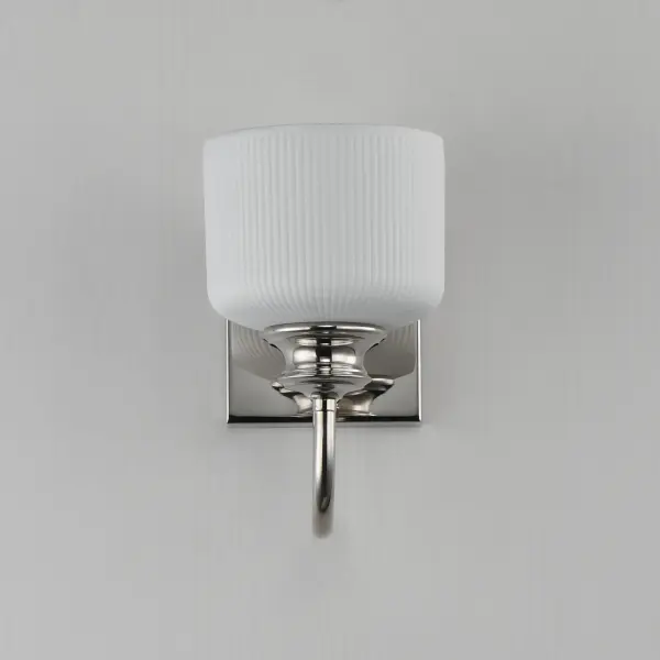 Ribbed ceramic shades are gracefully suspended on classic arching tube frames, creating a timeless yet modern design. The matte bisque-fired ceramic is translucent softly diffuses light while highlighting the ribbed raised pattern. Available in elegant finishes, choose from Natural Aged Brass, Oil Rubbed Bronze, or Polished Nickel frames to complement your space. Collection: Bisque Finish: Polished Nickel Glass: White Width: 5.50" Height: 10.00" Weight: 2.20 lb Extension from Wall: 9.00" Wire: 8" Canopy: 6"x4.75" Number of Bulbs: 1 Maximum Wattage: 60.00 W Bulb Base: E26 Medium Light Source: Incandescent Dimmable Voltage: 120.00 V Material: Steel, Glass Safety Listing: cETLus Safety Rating: Damp Spec Sheet Instructions - alternate view