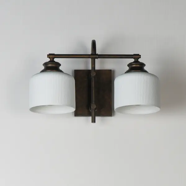 Ribbed ceramic shades are gracefully suspended on classic arching tube frames, creating a timeless yet modern design. The matte bisque-fired ceramic is translucent softly diffuses light while highlighting the ribbed raised pattern. Available in elegant finishes, choose from Natural Aged Brass, Oil Rubbed Bronze, or Polished Nickel frames to complement your space. Collection: Bisque Finish: Oil Rubbed Bronze Glass: White Width: 16.00" Height: 10.00" Weight: 3.74 lb Extension from Wall: 9.00" Wire: 8" Canopy: 6"x4.75" Number of Bulbs: 2 Maximum Wattage: 60.00 W Bulb Base: E26 Medium Light Source: Incandescent Dimmable Voltage: 120.00 V Material: Steel, Glass Safety Listing: cETLus Safety Rating: Damp Spec Sheet Instructions - alternate view