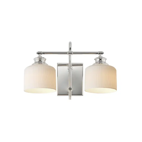 Ribbed ceramic shades are gracefully suspended on classic arching tube frames, creating a timeless yet modern design. The matte bisque-fired ceramic is translucent softly diffuses light while highlighting the ribbed raised pattern. Available in elegant finishes, choose from Natural Aged Brass, Oil Rubbed Bronze, or Polished Nickel frames to complement your space. Collection: Bisque Finish: Polished Nickel Glass: White Width: 16.00" Height: 10.00" Weight: 3.74 lb Extension from Wall: 9.00" Wire: 8" Canopy: 6"x4.75" Number of Bulbs: 2 Maximum Wattage: 60.00 W Bulb Base: E26 Medium Light Source: Incandescent Dimmable Voltage: 120.00 V Material: Steel, Glass Safety Listing: cETLus Safety Rating: Damp Spec Sheet Instructions