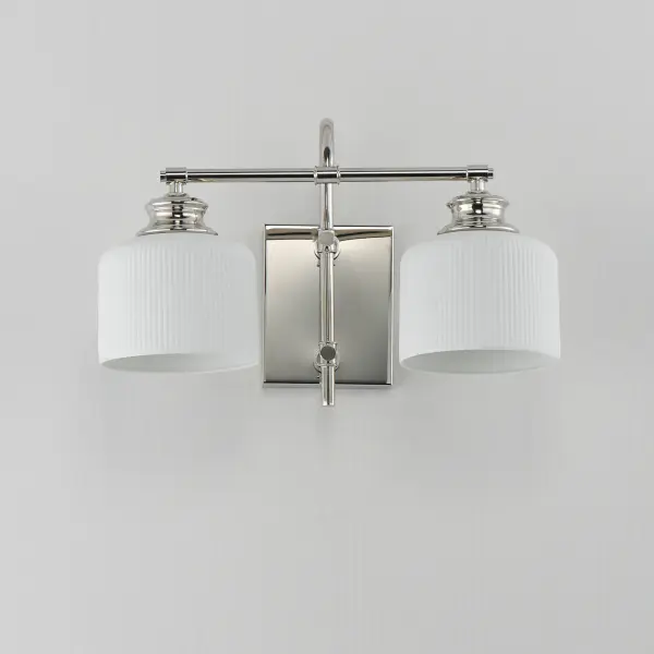 Ribbed ceramic shades are gracefully suspended on classic arching tube frames, creating a timeless yet modern design. The matte bisque-fired ceramic is translucent softly diffuses light while highlighting the ribbed raised pattern. Available in elegant finishes, choose from Natural Aged Brass, Oil Rubbed Bronze, or Polished Nickel frames to complement your space. Collection: Bisque Finish: Polished Nickel Glass: White Width: 16.00" Height: 10.00" Weight: 3.74 lb Extension from Wall: 9.00" Wire: 8" Canopy: 6"x4.75" Number of Bulbs: 2 Maximum Wattage: 60.00 W Bulb Base: E26 Medium Light Source: Incandescent Dimmable Voltage: 120.00 V Material: Steel, Glass Safety Listing: cETLus Safety Rating: Damp Spec Sheet Instructions - alternate view