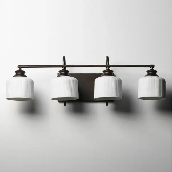 Ribbed ceramic shades are gracefully suspended on classic arching tube frames, creating a timeless yet modern design. The matte bisque-fired ceramic is translucent softly diffuses light while highlighting the ribbed raised pattern. Available in elegant finishes, choose from Natural Aged Brass, Oil Rubbed Bronze, or Polished Nickel frames to complement your space. Collection: Bisque Finish: Oil Rubbed Bronze Glass: White Width: 32.00" Height: 10.00" Weight: 7.48 lb Extension from Wall: 9.00" Wire: 8" Canopy: 6"x12" Number of Bulbs: 4 Maximum Wattage: 60.00 W Bulb Base: E26 Medium Light Source: Incandescent Dimmable Voltage: 120.00 V Material: Steel, Glass Safety Listing: cETLus Safety Rating: Damp Spec Sheet Instructions - alternate view