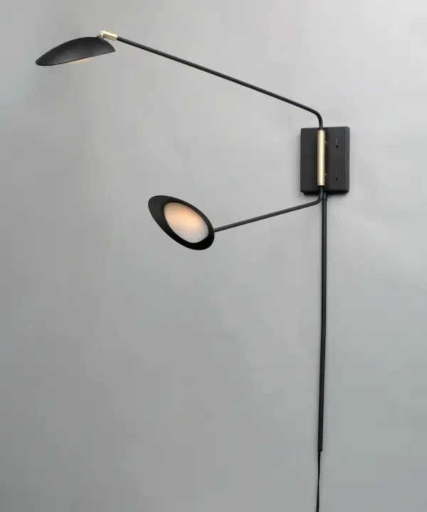 Inspired by Mid-Century Modern design, this collection features tapered hoods that conceal LED modules that can be adjusted to direct the light. The Black finish with contrasting Satin Brass accents softens the look to work in a broader range of design. The wall pin up lamps work great at bedside while the floor lamp version is at home next to a chair. - alternate view