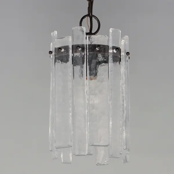 Gracefully flowing molten glass panels with uniquely organic aesthetic encircle rings of rich Darkened Bronze metal or hand-applied Gold Leaf. This refined interpretation of tiered glass pendants exudes warmth and elegance, effortlessly blending a moody ambiance with timeless contemporary charm. Available in a variety of pendant configurations as well as coordinating wall sconce and semi-flush mount. - alternate view