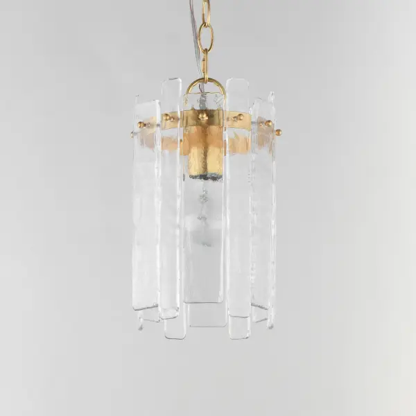 Gracefully flowing molten glass panels with uniquely organic aesthetic encircle rings of rich Darkened Bronze metal or hand-applied Gold Leaf. This refined interpretation of tiered glass pendants exudes warmth and elegance, effortlessly blending a moody ambiance with timeless contemporary charm. Available in a variety of pendant configurations as well as coordinating wall sconce and semi-flush mount. Collection: Warren Finish: Dark Bronze Glass: Artisan Width: 7.50" Height: 12.00" Length: 7.50" Weight: 3.00 lb Chain: 36" Wire: 120" Canopy: 5"x5"x1" Number of Bulbs: 1 Maximum Wattage: 60.00 W Bulb Base: E26 Medium Light Source: Incandescent Dimmable Voltage: 120.00 V Material: Steel, Glass Safety Listing: cETLus Safety Rating: Dry Spec Sheet Instructions - alternate view