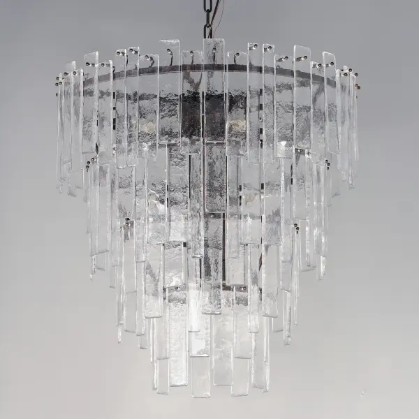 Gracefully flowing molten glass panels with uniquely organic aesthetic encircle rings of rich Darkened Bronze metal or hand-applied Gold Leaf. This refined interpretation of tiered glass pendants exudes warmth and elegance, effortlessly blending a moody ambiance with timeless contemporary charm. Available in a variety of pendant configurations as well as coordinating wall sconce and semi-flush mount. - alternate view
