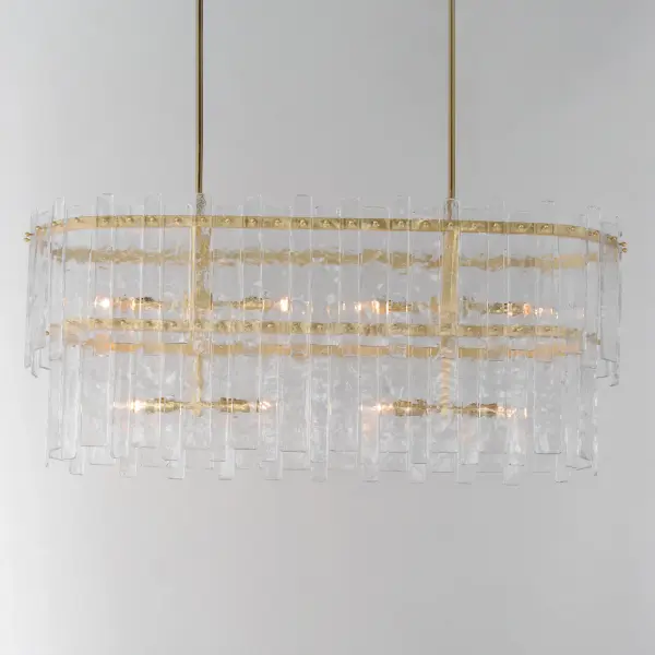 Gracefully flowing molten glass panels with uniquely organic aesthetic encircle rings of rich Darkened Bronze metal or hand-applied Gold Leaf. This refined interpretation of tiered glass pendants exudes warmth and elegance, effortlessly blending a moody ambiance with timeless contemporary charm. Available in a variety of pendant configurations as well as coordinating wall sconce and semi-flush mount. Collection: Warren Finish: Gold Leaf Glass: Artisan Width: 12.00" Height: 19.00" Length: 42.00" Weight: 52.80 lb Wire: 120" Canopy: 20"x5"x1" Number of Bulbs: 8 Maximum Wattage: 60.00 W Bulb Type: Candelabra Bulb Base: E12 Candelabra Light Source: Incandescent Voltage: 120.00 V Material: Steel, Glass Safety Listing: cETLus Safety Rating: Dry Manufacturer Warranty: 2 Spec Sheet - alternate view
