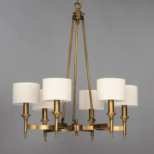 Arched channels of metal finished in your choice of Natural Aged Brass or Polished Nickel, form this minimalistic approach to traditional lighting.  Oatmeal fabric shades adorn the top of metal candle covers that give this collection a tailored look. - alternate view