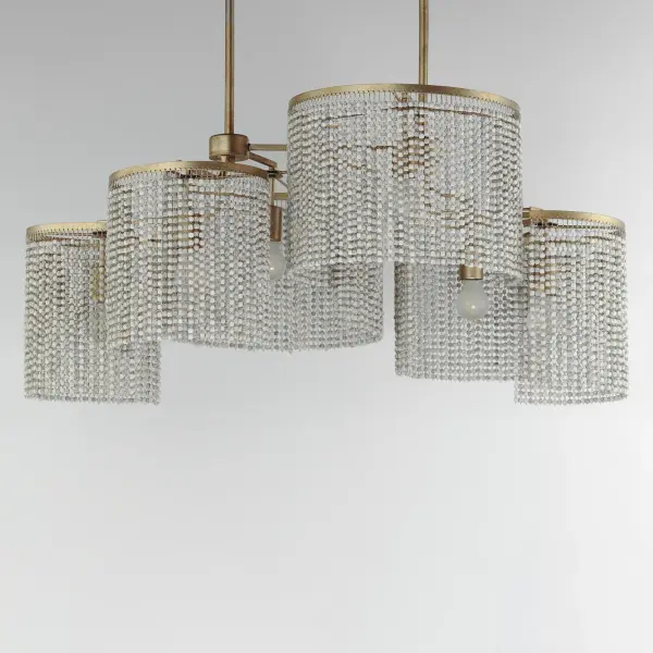Cascading strands of square Weathered Wood beads are suspended on an offset spiraling frame finished in hand-applied Golden Silver leaf. The craftsmanship of the design is complimented by the soft glow of light within adding ambience to any space. Available in two sizes of pendants, a semi-flush mount, linear chandelier and large wall sconce. - alternate view