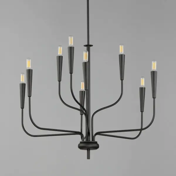 A simple candle style chandelier is given a modern edge with tall tapered candle covers that sit at the ends of curved arms without a bobeche beneath them. Available in Satin Brass or Matte Black, the collection compliments many architectural interiors and allows for creative styling through the selection of lamp type. Pair with our T6 lamp for more modern, industrial flair or classic candelabra for a clean, transitional look. This series provides a convenient new take on the candle chandelier with subtle and unique design details. - alternate view