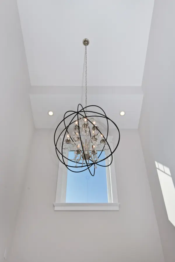 A spherical frame of metal surround a simple line chandelier draped in crystal for a transitional style that fits any interior design.  Orbit is available in 2 sizes and 2 finishes, Oil Rubbed Bronze with Cognac crystal and a combo finish of Anthracite and Polished Nickel with Clear crystal. - alternate view