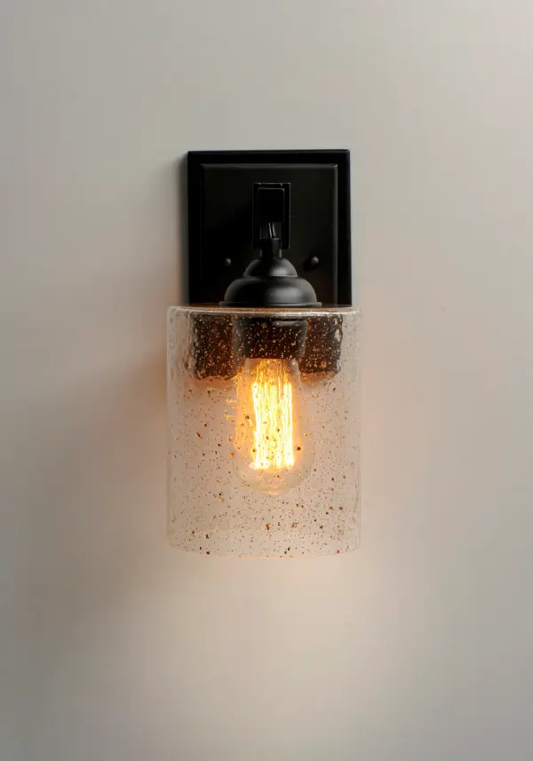 Stone Seeded glass shades with flecks of gold, suspend from a squared loop that cradles a rectangular tube arm finished in a soft Bronze. The minimalistic frame is a perfect complement to the rustic glamour of this glass. - alternate view