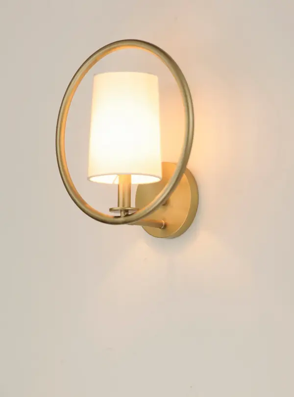 Heavy gauge rings are painted in Natural Aged Brass for a traditional approach to contemporary design. Nested in the center of each ring is a tall profile Off White fabric shade which casts soft light into the room and projects ample light to the surface below. - alternate view