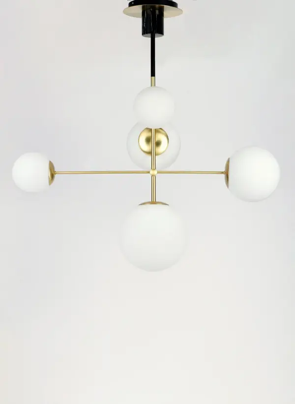 Inspired by both Mid Century Modern and Scandinavian Contemporary this collection spans a large breadth of today's interior design. Straight tubing finished in Satin Brass supports hand blown Satin White cased glass globes. Black accents of metal and Black marble add dramatic detail and upscale appeal. - alternate view