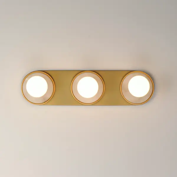 Get ready for your closeup. This collection of streamlined vanity lights are available in glamorous two tone finishes. Select from Polished Chrome with reversible Black and White plates or Natural Aged Brass with Matte Black or Spanish Alabaster plates. Globes of LED G25 lamps are available with the fixture. Collection: Hollywood Finish: Whit Alabaster / Natural Aged Brass Width: 20.00" Height: 5.00" Weight: 3.30 lb Extension from Wall: 2.75" Wire: 8" Canopy: 5"x20" Number of Bulbs: 3 Maximum Wattage: 60.00 W Bulb Type: G25 Bulb Base: E26 Medium Light Source: Incandescent Light Output: 1170.00 lm Color Temperature: 3000 K CRI: 90 Dimmable Rated Average Life: 25000 Voltage: 120.00 V Material: Steel, Aluminum, Ceramic, Alabaster Safety Rating: Damp ADA Spec Sheet Instructions - alternate view