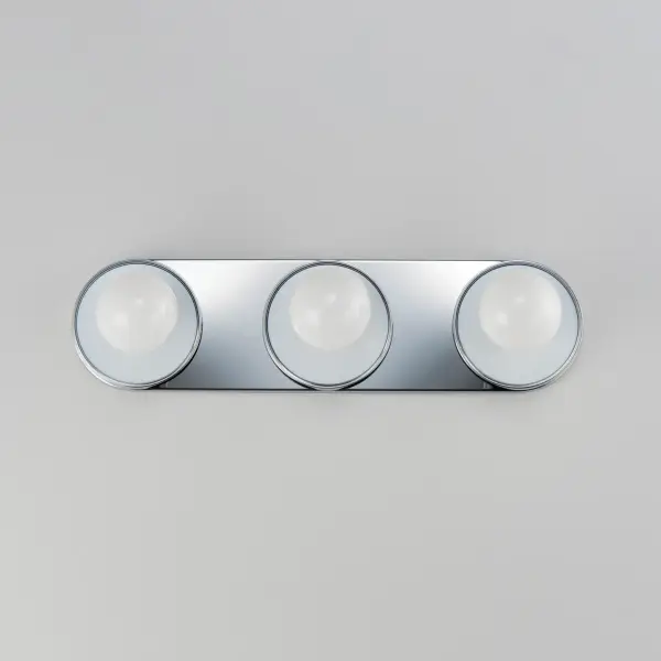 Get ready for your closeup. This collection of streamlined vanity lights are available in glamorous two tone finishes. Select from Polished Chrome with reversible Black and White plates or Natural Aged Brass with Matte Black or Spanish Alabaster plates. Globes of LED G25 lamps are available with the fixture. Collection: Hollywood Finish: Black / Polished Chrome Glass: White Width: 20.00" Height: 5.00" Weight: 2.60 lb Extension from Wall: 2.50" Wire: 8" Canopy: 5"x20" Number of Bulbs: 3 Maximum Wattage: 60.00 W Bulb Type: G25 Bulb Base: E26 Medium Light Source: Incandescent Dimmable Voltage: 120.00 V Material: Steel, Aluminum, Ceramics Safety Listing: cETLus Safety Rating: Damp ADA Manufacturer Warranty: 2 Spec Sheet Instructions - alternate view