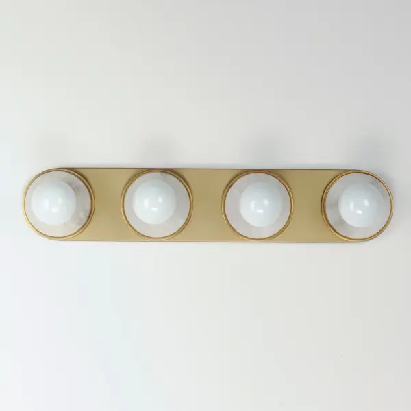 Get ready for your closeup. This collection of streamlined vanity lights are available in glamorous two tone finishes. Select from Polished Chrome with reversible Black and White plates or Natural Aged Brass with Matte Black or Spanish Alabaster plates. Globes of LED G25 lamps are available with the fixture. Collection: Hollywood Finish: Whit Alabaster / Natural Aged Brass Width: 26.50" Height: 5.00" Weight: 3.56 lb Extension from Wall: 2.50" Wire: 8" Canopy: 5"x26.5" Number of Bulbs: 4 Maximum Wattage: 60.00 W Bulb Type: G25 Bulb Base: E26 Medium Light Source: Incandescent Light Output: 1560.00 lm Color Temperature: 3000 K CRI: 90 Dimmable Rated Average Life: 25000 Voltage: 120.00 V Material: Steel, Aluminum, Ceramics Safety Rating: Damp ADA Spec Sheet Instructions - alternate view