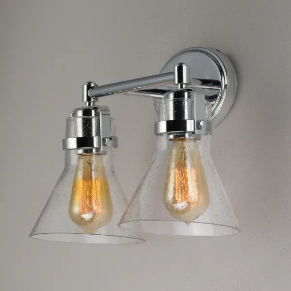 This nautical-inspired collection features Clear Seedy glass cones suspended by a yoke frame. The clear glass offers abundant lighting and compliments the styling of the fixture. Make it a more industrial look by adding filament E26 light bulbs. Collection: Seafarer Finish: Polished Chrome Glass: Seedy Width: 15.00" Height: 10.00" Weight: 4.18 lb Extension from Wall: 7.00" Wire: 8" Canopy: 4.5"x7" Number of Bulbs: 2 Maximum Wattage: 60.00 W Bulb Type: A19 Bulb Base: E26 Medium Light Source: Incandescent Dimmable Voltage: 120.00 V Material: Steel, Glass Safety Listing: cETLus Safety Rating: Damp Manufacturer Warranty: 1 Spec Sheet Instructions Parts Diagram - alternate view