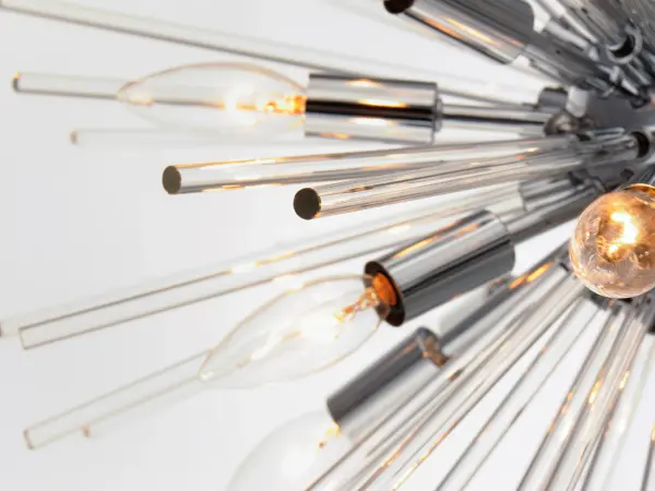 A dazzling burst of Clear glass rods extend from a classic sputnik shape finished in a bright Polished Chrome or warm Satin Brass. Available in two sizes of pendants and as a ceiling fixture, this unique look is a statement piece designed to attract attention. - alternate view