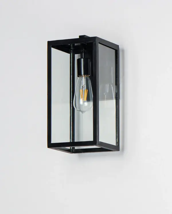 An elongated rectangular shaped design that is both minimalist and industrial. Die cast frames of Dark Bronze support Clear glass panels that provide an unobstructed view of the lantern's interior. Customize with your choice of lamps from vintage to tubular. - alternate view