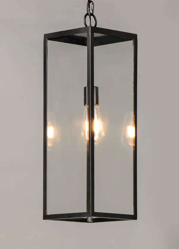 An elongated rectangular shaped design that is both minimalist and industrial. Die cast frames of Dark Bronze support Clear glass panels that provide an unobstructed view of the lantern's interior. Customize with your choice of lamps from vintage to tubular. - alternate view