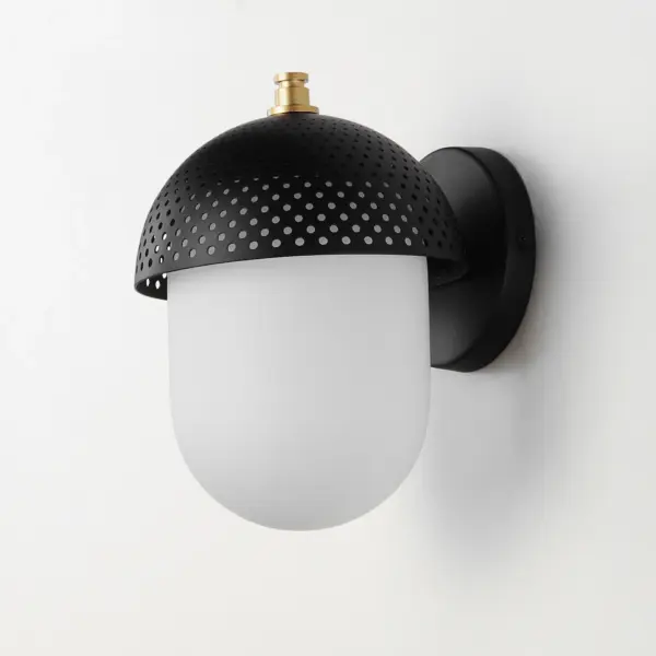 Behind a Black perforated metal dome, an elongated White glass globe casts soft lighting with an intriguing lighting effect through the filigree. Finished in outdoor rated powder coat of Black and Gold make this a spirited two-tone addition to an already popular mid-century inspired collection of interior pendants and flush mounts. - alternate view