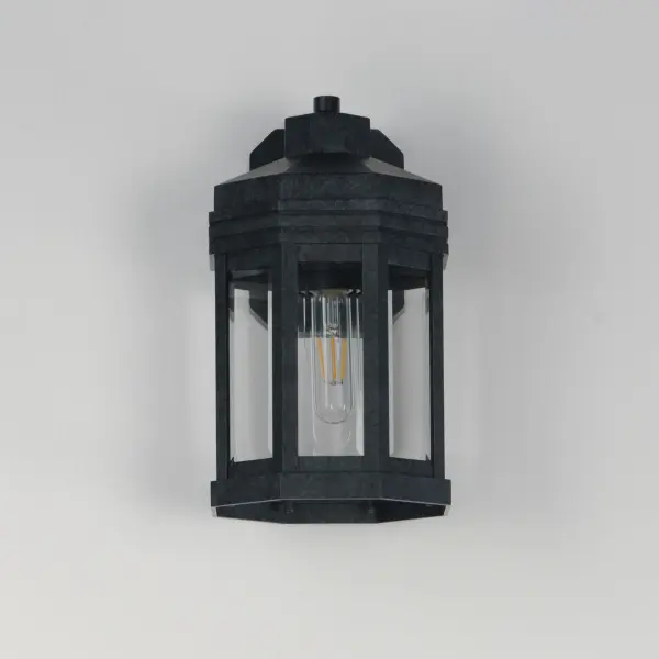 Inspired by the intricate geometric motifs of the iconic architect, the Wright collection of outdoor lighting features a hexagonal frame with tiered louvers along its hood. Beveled at its edges, the Clear glass panes encase the lighting cluster within a robust die cast aluminum body and aluminum frame. Finished in a rich Black Patina, this outdoor series provides thoughtful touches and rich finishes to make a timelessly elegant lighting collection. - alternate view