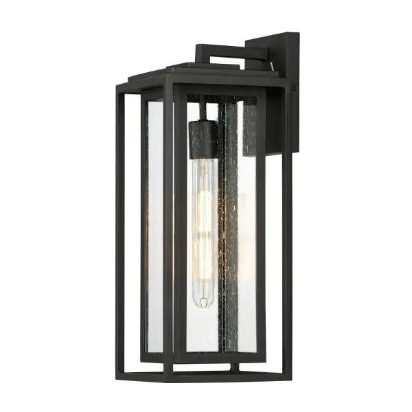 A dual framed structure creates dimension on these outdoor lighting fixtures that is both contemporary and transitional. The construction consists of two frames of square tubing and squared components. The inner frame's Clear Seedy glass reduces glare from the light and appears dirt-free for longer periods. This is a comprehensive collection to brighten all areas of your outdoor space, available in various sized sconces as well as hanging and post configurations.