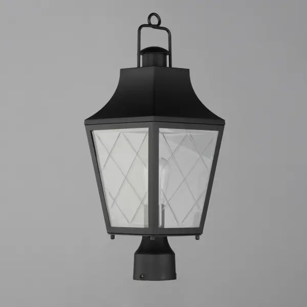 These charming cottage style lanterns feature unique cross-etched glass panels that are Clear and beveled along their edges. Additional design details such as whimsical loops above a chimney element add to the product's delightful appearance. Finished in a Matte Black outdoor rated powder coat, this collection recaptures the appeal of storybook lanterns. - alternate view
