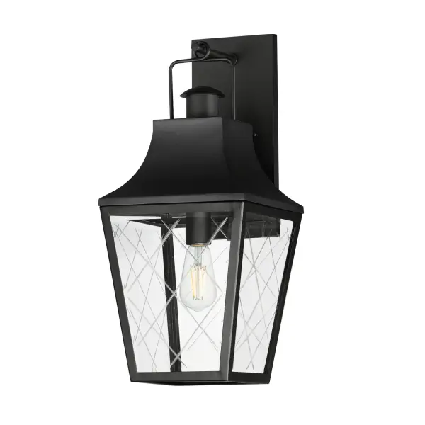 These charming cottage style lanterns feature unique cross-etched glass panels that are Clear and beveled along their edges. Additional design details such as whimsical loops above a chimney element add to the product's delightful appearance. Finished in a Matte Black outdoor rated powder coat, this collection recaptures the appeal of storybook lanterns.