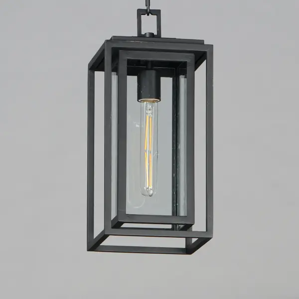A dual framed structure creates dimension on these outdoor lighting fixtures that is both contemporary and transitional. The construction consists of two frames of square tubing and squared components. The inner frame's Clear Seedy glass reduces glare from the light and appears dirt-free for longer periods. This is a comprehensive collection to brighten all areas of your outdoor space, available in various sized sconces as well as hanging and post configurations. - alternate view