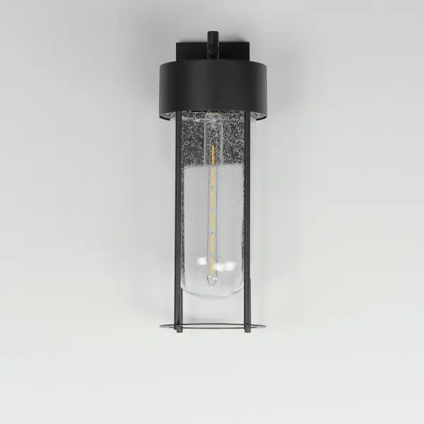 Clean and contemporary, this series of wet location rated outdoor sconces features a capsule of Clear Seeded glass encased within a cage of matte Black outdoor rated powder coat. The transitional appeal of the design pairs well in applications both modern and traditional. Complete the look with a tubular filament lamp. - alternate view