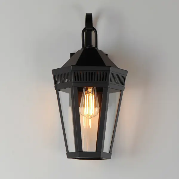 Stately lanterns with perforated filigree along the hood casts a beautiful lighting effect. Finished in Matte Black, the collection is available in multiple sizes as well as flush mount, deck lantern, and two sizes of pendants. - alternate view