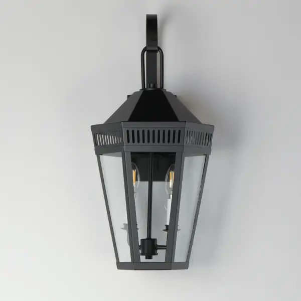 Stately lanterns with perforated filigree along the hood casts a beautiful lighting effect. Finished in Matte Black, the collection is available in multiple sizes as well as flush mount, deck lantern, and two sizes of pendants. - alternate view