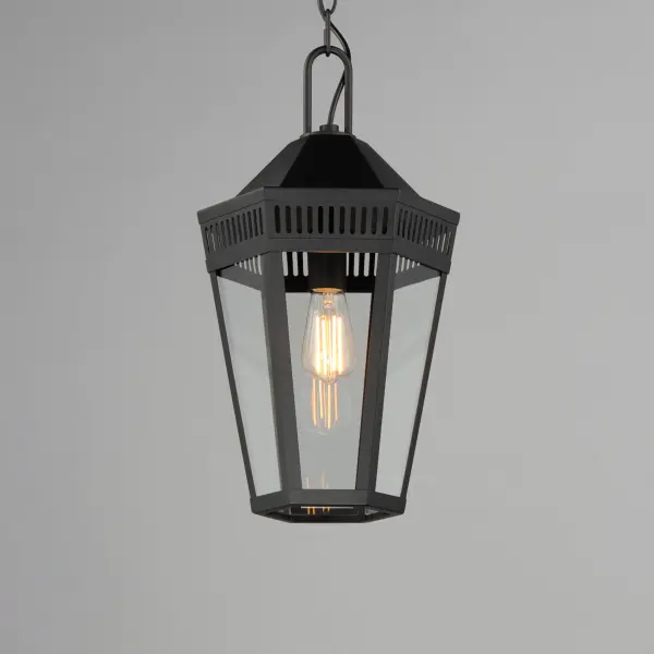 Stately lanterns with perforated filigree along the hood casts a beautiful lighting effect. Finished in Matte Black, the collection is available in multiple sizes as well as flush mount, deck lantern, and two sizes of pendants. - alternate view