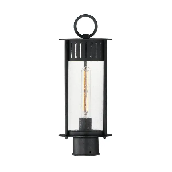 Inspired by the rounded towers of Windsor Castle, this outdoor lighting collection features a hand-applied Black Patina finish on Stainless Steel. A slotted filigree along the top of the cylinder frame allows light to escape, while the clear seeded glass obscures the light source enough to soften the glare a light bulb casts.