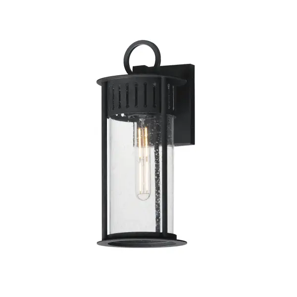 Inspired by the rounded towers of Windsor Castle, this outdoor lighting collection features a hand-applied Black Patina finish on Stainless Steel. A slotted filigree along the top of the cylinder frame allows light to escape, while the clear seeded glass obscures the light source enough to soften the glare a light bulb casts.
