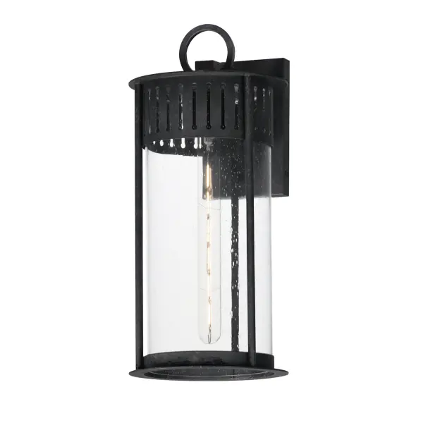 Inspired by the rounded towers of Windsor Castle, this outdoor lighting collection features a hand-applied Black Patina finish on Stainless Steel. A slotted filigree along the top of the cylinder frame allows light to escape, while the clear seeded glass obscures the light source enough to soften the glare a light bulb casts.