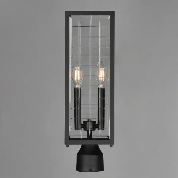 A simple square-framed lantern features deep etched squares on Clear glass, creating a captivating array of refracted light. Constructed from die-cast aluminum and finished in Matte Black, the design blends classic elements with a refreshing, modern approach, offering both sophistication and simplicity with an emphasis on minimalism. - alternate view