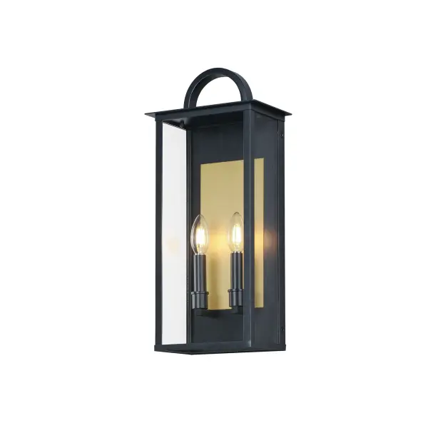 The Manchester series is inspired by classic coach lanterns and consists of minimally extended sconces in a variety of sizes that have been modified with simplified embellishments. The black frames have been modified with a squared arc handle and a contrasting Burnished Gold plate that reflects clusters of candle lights surrounded by Clear glass panels. This collection references historic exterior sconces while modernizing their appearance. Complement the design with tubular lamps to accentuate the verticality of the frames.