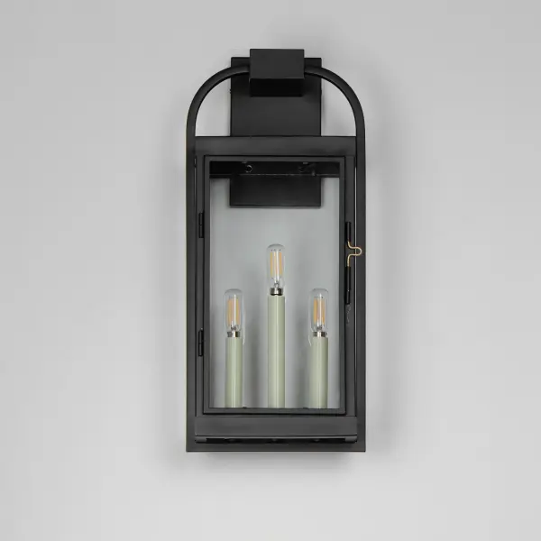 Inspired by classic English lantern design, this collection of outdoor sconces have been streamlined for modern appeal. A convenient, and quaint front door latch allows you to clean and maintain the fixture. Finished in a clean, Matte Black finish with brass hardware and Clear glass panels, two sets of candle sleeves are provided to choose from matching black sleeves or contrasting off-white for a more transitional outlook. - alternate view