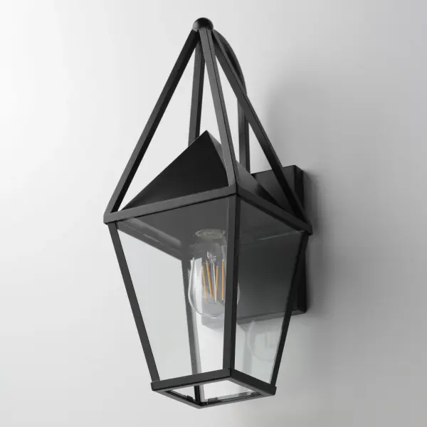 An exaggerated openwork framed steeple adds vertical qualities on a sharp-lined Matte Black lantern frame. Blending modern concepts with forms that evoke a whimsical imagery, this collection presents a transitional styling for outdoor spaces. - alternate view